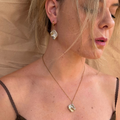 Mother of pearl gold pendant necklace worn by a model – Feminine Creatures