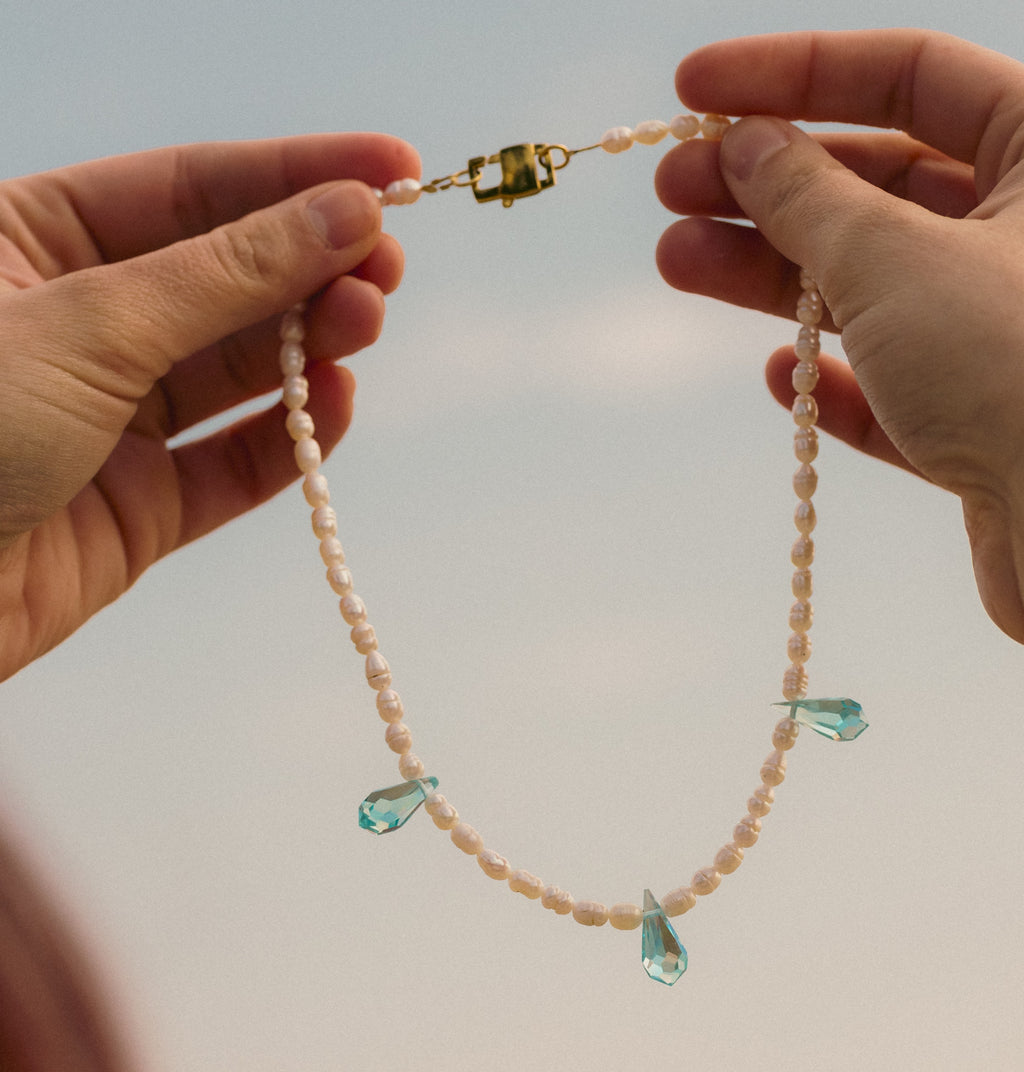 Siren freshwater pearl and blue crystal necklace worn by a model – Feminine Creatures